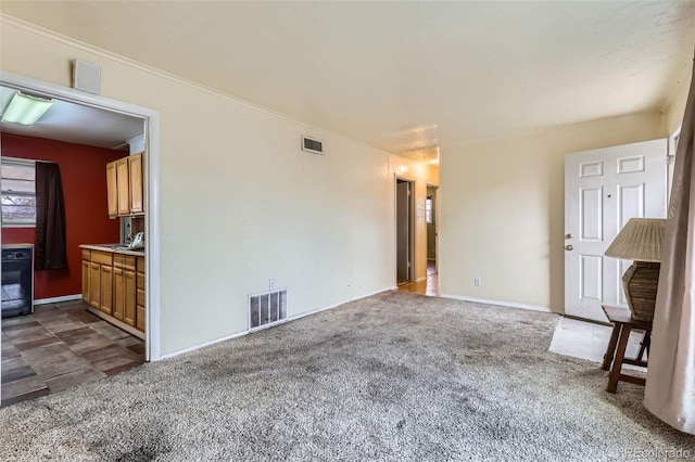 unfurnished living room with dark carpet and ornamental molding