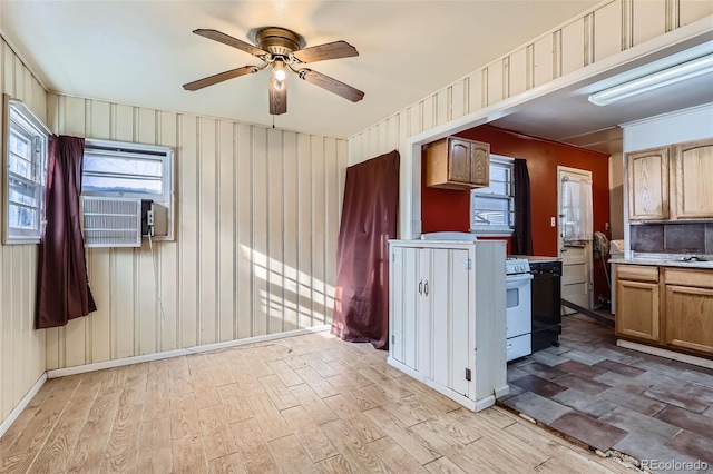 kitchen featuring ceiling fan, light hardwood / wood-style flooring, cooling unit, white stove, and ornamental molding