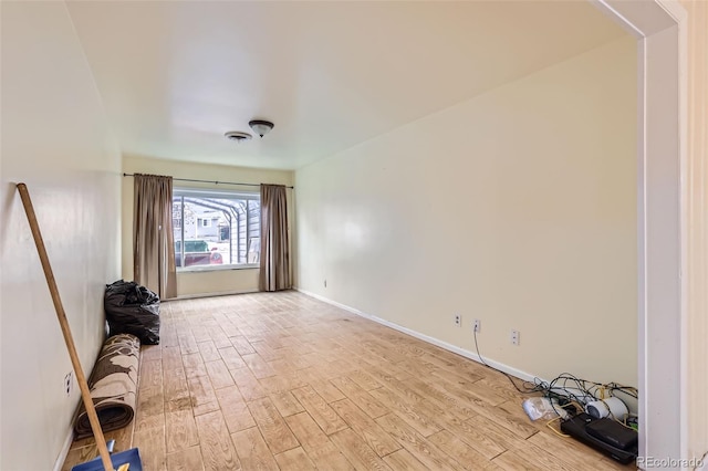 empty room with light hardwood / wood-style flooring