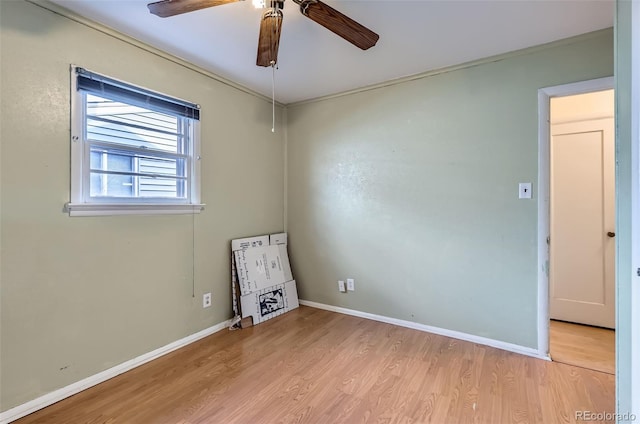 empty room with light hardwood / wood-style flooring, ceiling fan, and ornamental molding