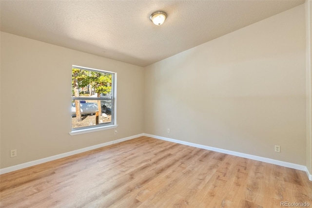 140 Beaver Rd, Idaho Springs, CO 80452 - empty room featuring light wood-type flooring, a textured ceiling, and baseboards