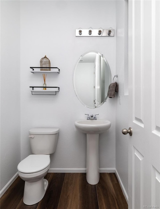 bathroom with toilet and hardwood / wood-style floors