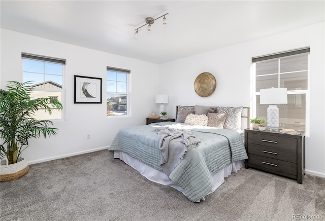 carpeted bedroom with track lighting