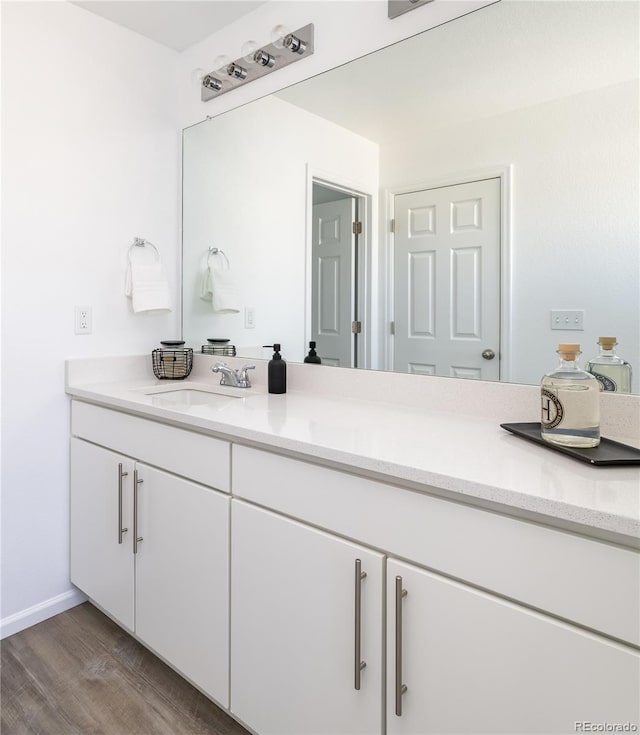 bathroom with hardwood / wood-style flooring and vanity