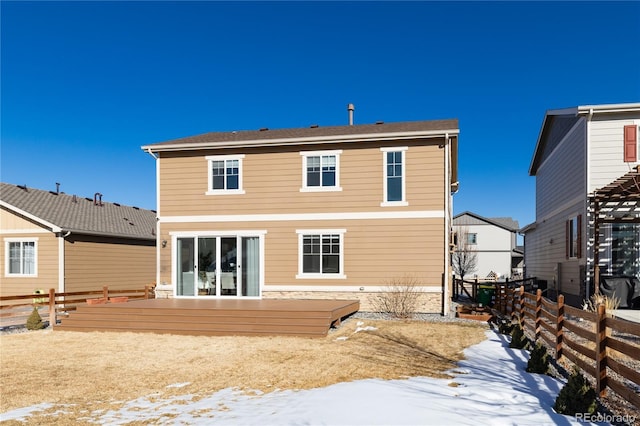 snow covered property with a deck