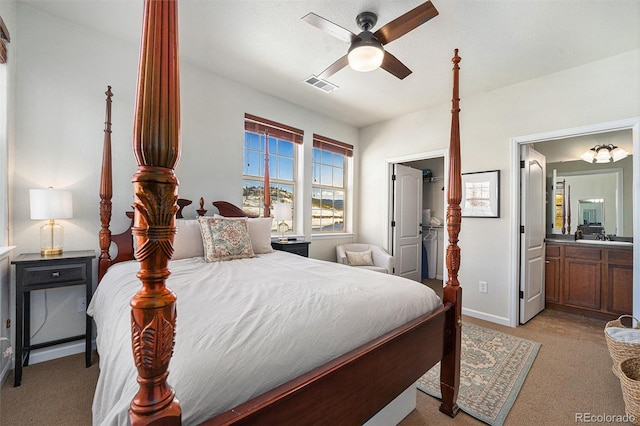 bedroom with a closet, visible vents, a spacious closet, connected bathroom, and baseboards