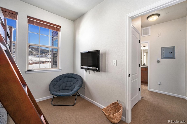 sitting room with baseboards, visible vents, electric panel, and carpet flooring