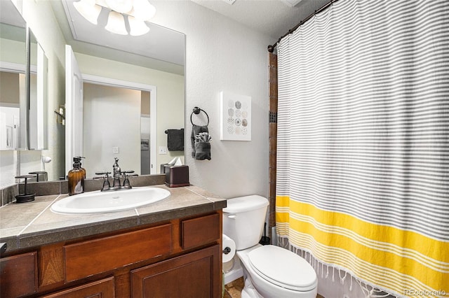 bathroom featuring a shower with shower curtain, vanity, and toilet