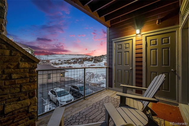 view of snow covered back of property