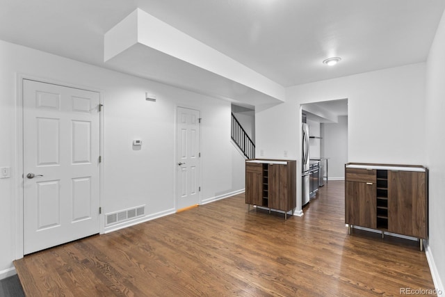 bonus room with dark wood-type flooring