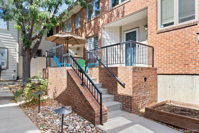 entrance to property featuring brick siding