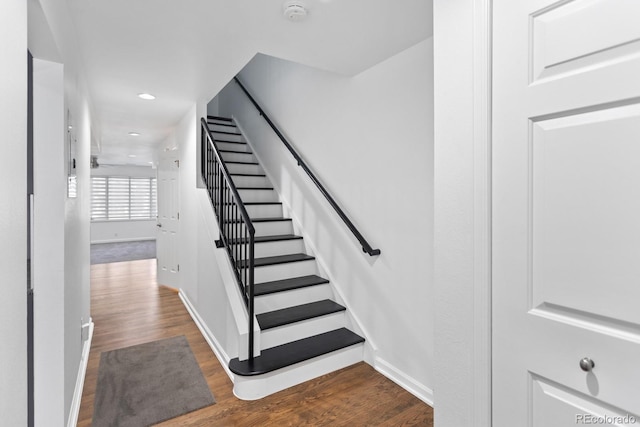 staircase with hardwood / wood-style flooring