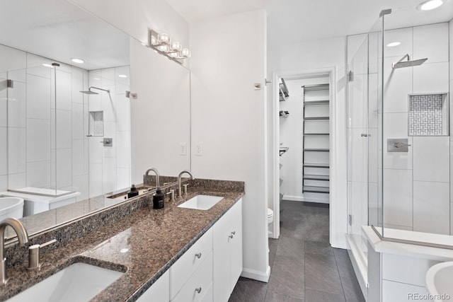 bathroom featuring vanity, tile patterned flooring, a shower with shower door, and toilet