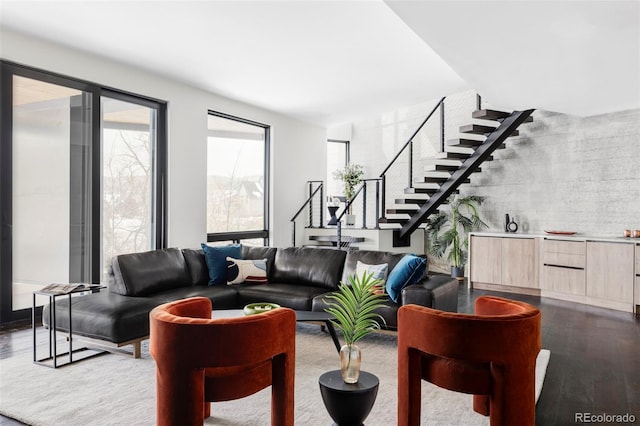 living area with dark wood-type flooring and stairway