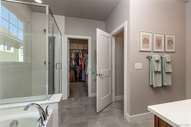 bathroom with tile patterned floors, vanity, and separate shower and tub