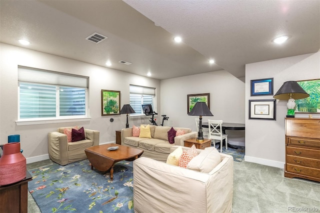 living room with light colored carpet and a textured ceiling