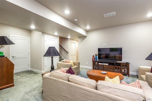 carpeted living room with a textured ceiling