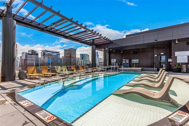 community pool with a patio area and a pergola