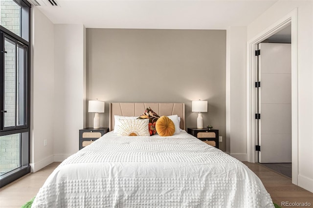 bedroom with light wood-style floors and baseboards