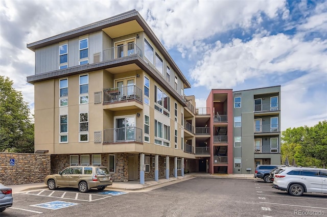 5201 S Fox St Unit 102, Littleton, CO 80120 - view of apartment building / complex featuring uncovered parking