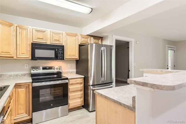 5201 S Fox St Unit 102, Littleton, CO 80120 - kitchen featuring appliances with stainless steel finishes, light brown cabinetry, light countertops, and light wood-style flooring