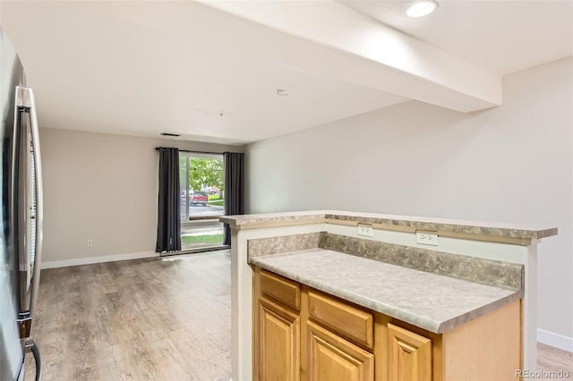 5201 S Fox St Unit 102, Littleton, CO 80120 - kitchen with freestanding refrigerator, light wood-style floors, light countertops, and light brown cabinetry