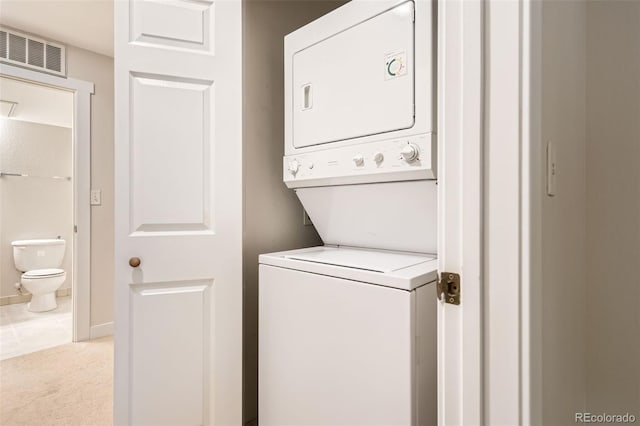 5201 S Fox St Unit 102, Littleton, CO 80120 - laundry area with estacked washer and dryer and light colored carpet