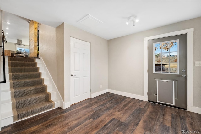 foyer entrance featuring stairway, wood finished floors, and baseboards