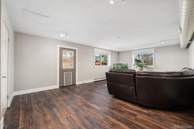 living room with baseboards, baseboard heating, and wood finished floors