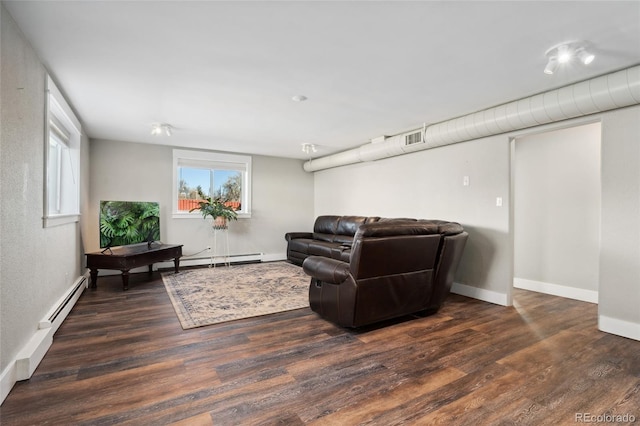 living room with a baseboard radiator, visible vents, baseboards, and wood finished floors