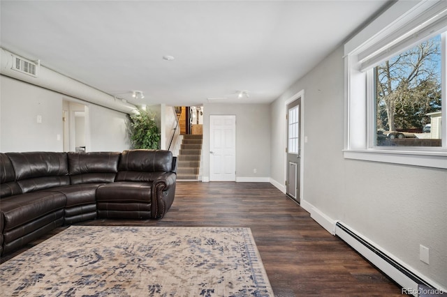 living room featuring dark wood-style floors, a baseboard radiator, visible vents, baseboards, and stairs