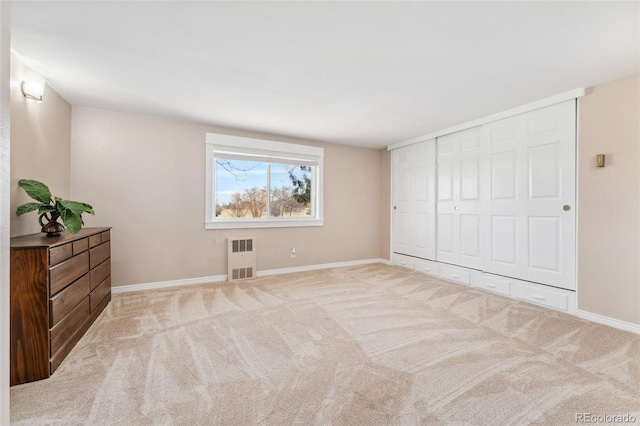 unfurnished bedroom with a closet, carpet flooring, and baseboards