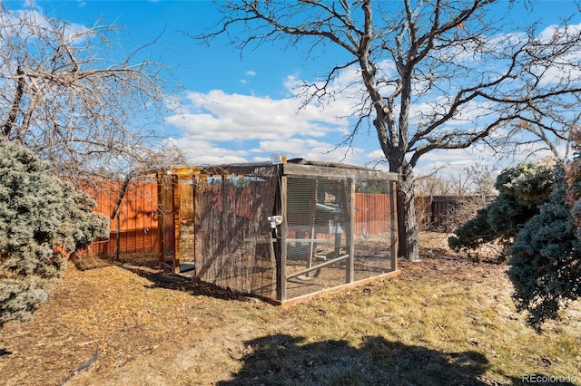 view of poultry coop featuring fence