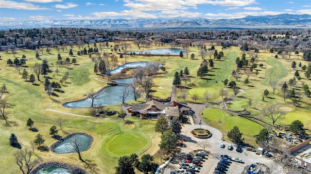 drone / aerial view with golf course view and a mountain view