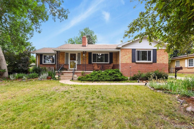 4040 Cody St, Wheat Ridge, CO 80033 - ranch-style home with a chimney, brick siding, a front yard, and covered porch