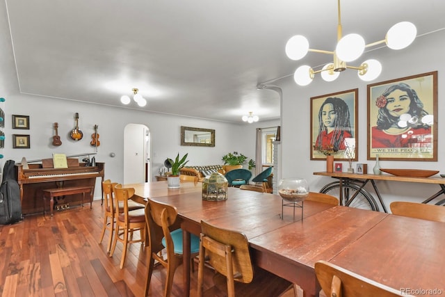 4040 Cody St, Wheat Ridge, CO 80033 - dining room with arched walkways, wood finished floors, and a chandelier