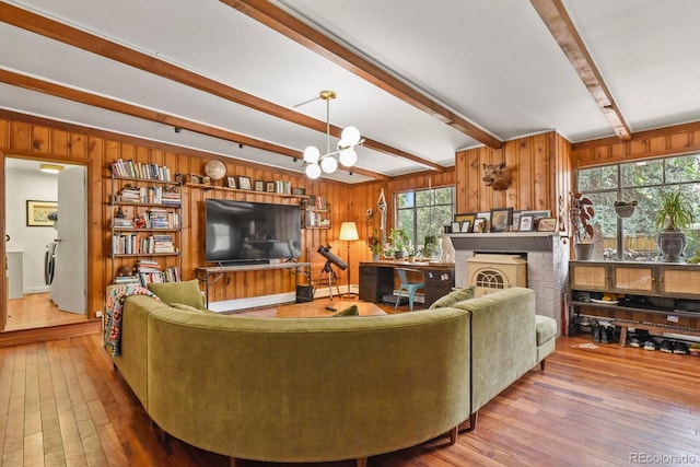 4040 Cody St, Wheat Ridge, CO 80033 - living area featuring beamed ceiling, wood-type flooring, wood walls, and a chandelier