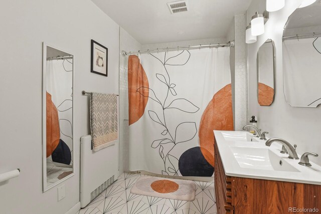 4040 Cody St, Wheat Ridge, CO 80033 - bathroom with double vanity, curtained shower, and tile patterned flooring