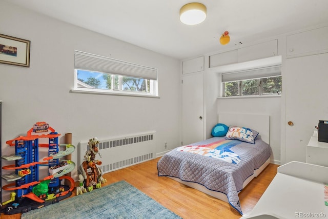 4040 Cody St, Wheat Ridge, CO 80033 - bedroom with radiator, multiple windows, and wood finished floors