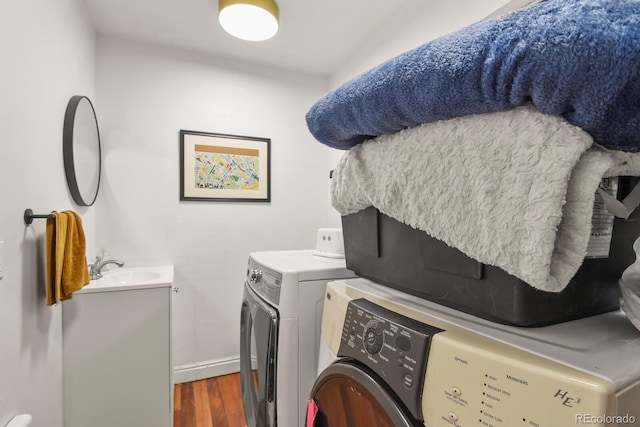 4040 Cody St, Wheat Ridge, CO 80033 - laundry room featuring washing machine and dryer and wood finished floors
