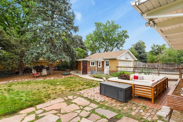 4040 Cody St, Wheat Ridge, CO 80033 - fenced backyard featuring an outbuilding, an outdoor living space, and a patio area