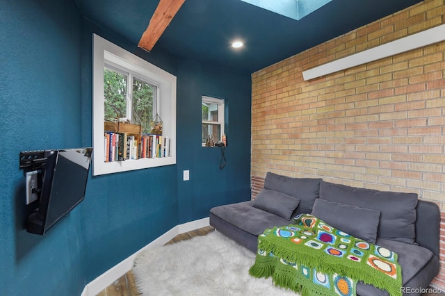 4040 Cody St, Wheat Ridge, CO 80033 - living room with brick wall, a skylight, and wood finished floors