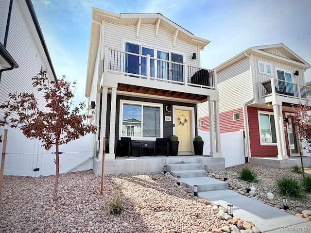 view of front of house featuring covered porch and a balcony