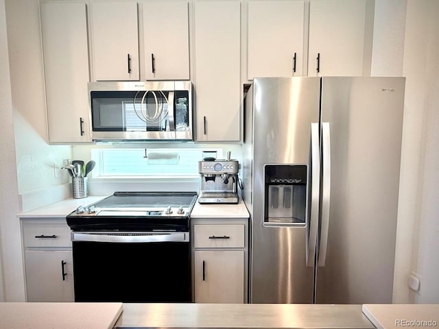 kitchen featuring light countertops, white cabinets, and stainless steel appliances