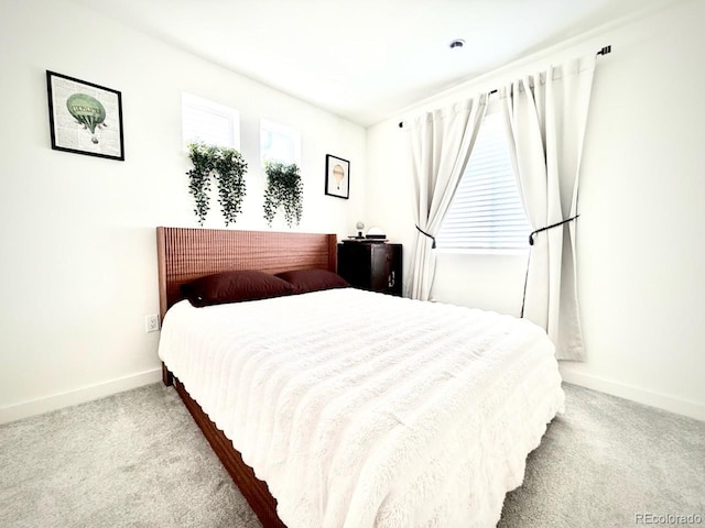 carpeted bedroom with baseboards