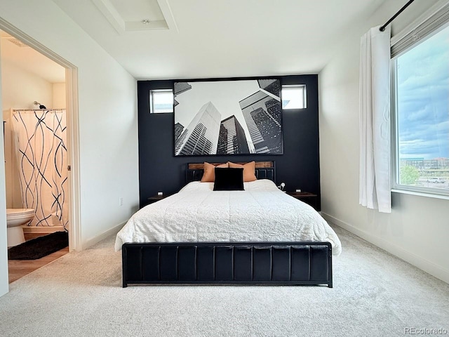 bedroom featuring carpet floors, baseboards, and attic access