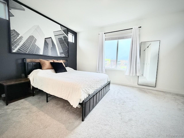 carpeted bedroom featuring baseboards