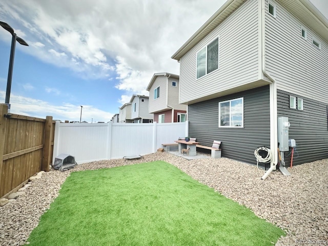 exterior space with a fenced backyard and a yard