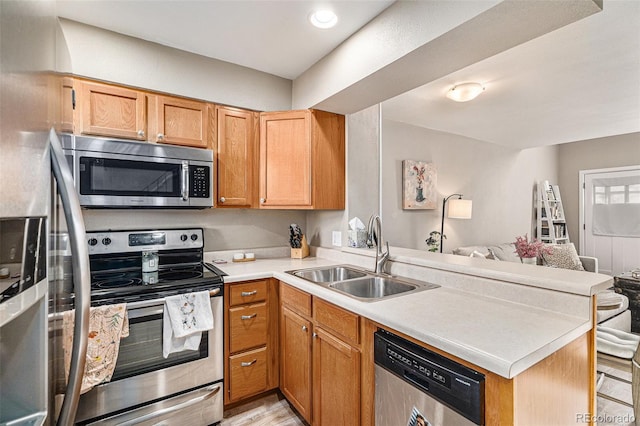 kitchen featuring appliances with stainless steel finishes, sink, and kitchen peninsula