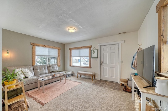 living room with carpet floors and a textured ceiling